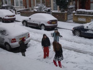 Four children playing in a snowy street